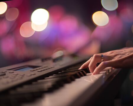 Fingers keyboardist on the background of the guitarist.の写真素材