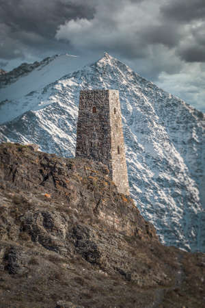 tower on the background of the caucasus mountains. North ossetiaのeditorial素材