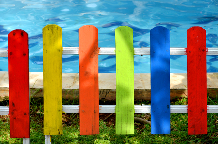 Colorful fence with swimming pool backgroundの写真素材
