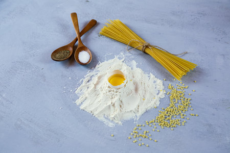 ingredients for homemade pasta. Food background: macaroni, spagetti, egg, flourの写真素材