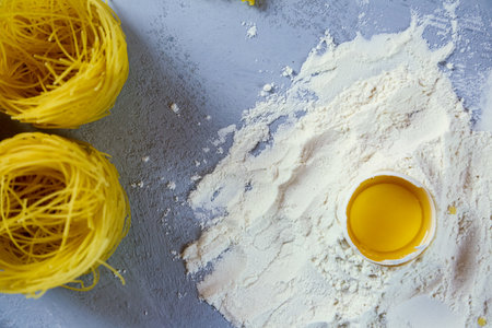 ingredients for homemade pasta. Food background: macaroni, spagetti, egg, flourの写真素材