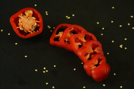 Red peppers on black background