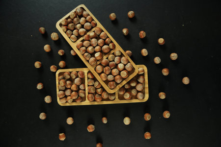Hazelnuts on wooden backdrop. heap or stack of hazelnuts. healty food