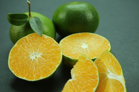 Green sweet tangerines growing with background