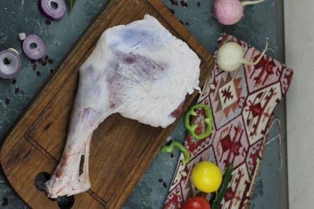 A butcher wrapping a piece of pork meat on a counterの写真素材