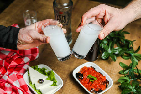 National Turkish alcoholic drink Raki and appetiser on tableの写真素材