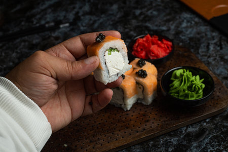 Traditional delicious fresh sushi roll set on a black background with reflection. Sushi roll with rice, red fish, salmon. Sushi menu. Japanese kitchen, restaurant. Seafood, asian foodの写真素材