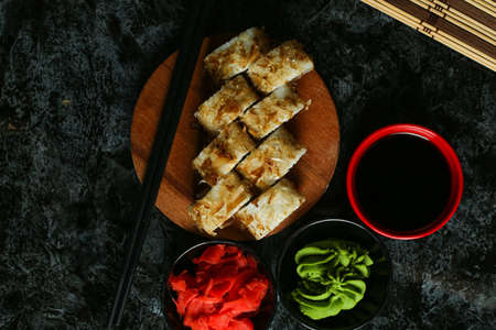 Traditional delicious fresh sushi roll set on a black background with reflection. Sushi roll with rice, red fish, salmon. Sushi menu. Japanese kitchen, restaurant. Seafood, asian foodの写真素材