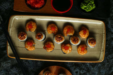 Traditional delicious fresh sushi roll set on a black background with reflection. Sushi roll with rice, red fish, salmon. Sushi menu. Japanese kitchen, restaurant. Seafood, asian foodの写真素材