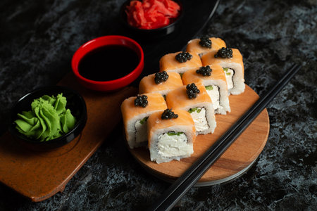 Traditional delicious fresh sushi roll set on a black background with reflection. Sushi roll with rice, red fish, salmon. Sushi menu. Japanese kitchen, restaurant. Seafood, asian foodの写真素材