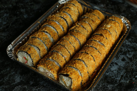 Hot fried Sushi Roll with salmon, avocado and cheese. Sushi menu. Japanese food.の写真素材