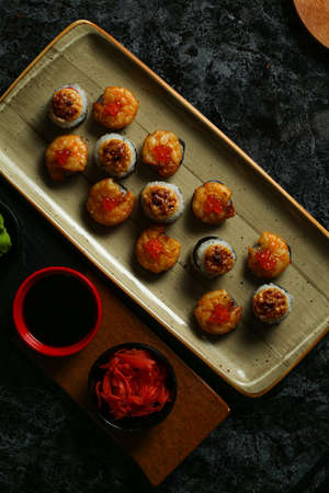 Traditional delicious fresh sushi roll set on a black background with reflection. Sushi roll with rice, red fish, salmon. Sushi menu. Japanese kitchen, restaurant. Seafood, asian foodの写真素材