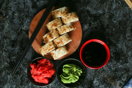 Traditional delicious fresh sushi roll set on a black background with reflection. Sushi roll with rice, red fish, salmon. Sushi menu. Japanese kitchen, restaurant. Seafood, asian foodの写真素材