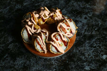 Hot fried Sushi Roll with salmon, avocado and cheese. Sushi menu. Japanese food.の写真素材