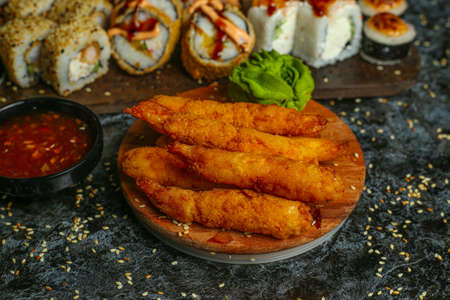 Traditional delicious fresh sushi roll set on a black background with reflection. Sushi roll with rice, red fish, salmon. Sushi menu. Japanese kitchen, restaurant. Seafood, asian foodの写真素材