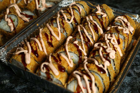 Hot fried Sushi Roll with salmon, avocado and cheese. Sushi menu. Japanese food.の写真素材