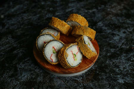 Hot fried Sushi Roll with salmon, avocado and cheese. Sushi menu. Japanese food.の写真素材