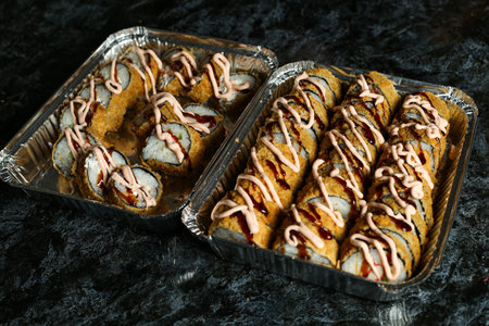 Hot fried Sushi Roll with salmon, avocado and cheese. Sushi menu. Japanese food.の写真素材