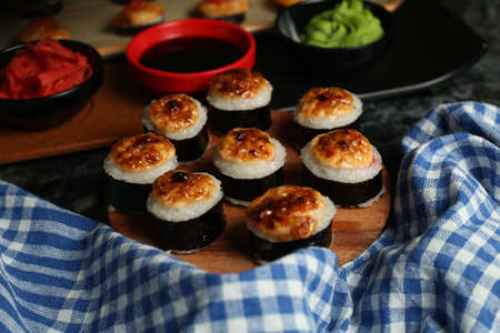 Traditional delicious fresh sushi roll set on a black background with reflection. Sushi roll with rice, red fish, salmon. Sushi menu. Japanese kitchen, restaurant. Seafood, asian foodの写真素材