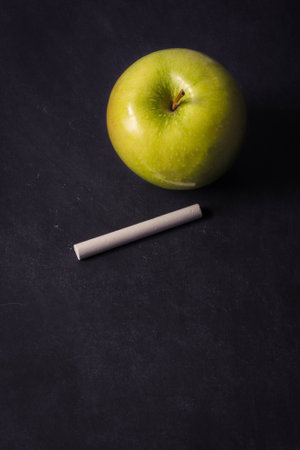 Green apple with chalk on chalk board for back to schoolの写真素材