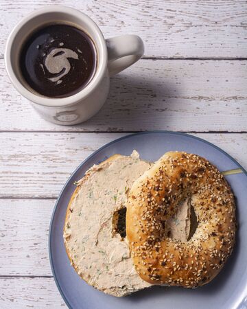 A delicious breakfast with an everything bagel, salmon spread and a cup of french press coffee.の写真素材