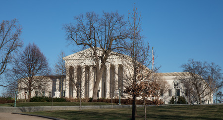 The Supreme Court building in Washington, D.C. in the winter with a bright blue sky.