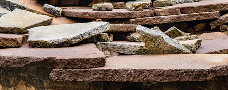 Broken slabs of stone scattered and layered on top of one another to create a background.の写真素材