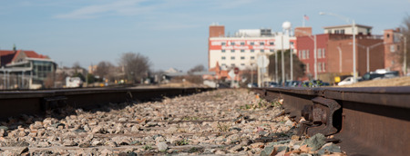 Railroad tracks from the ground level in an urban setting.の写真素材