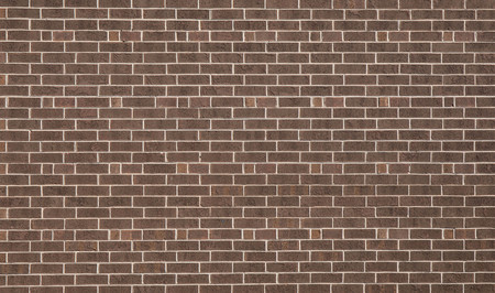 A dark brown brick wall for a textured and patterned background.