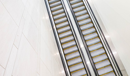 Both sets of up and down escalators in a hotel convention center with no one riding them.  and down...