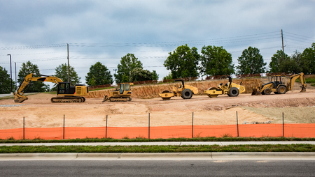 A row of heavy machinery equipment at a construction site.の写真素材