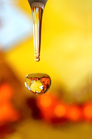 Liquid autumn. Drops of water and orange leafs.の写真素材