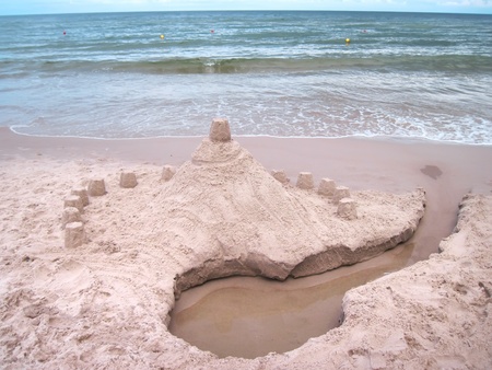 Sandy castle on the beach  Summer time の写真素材