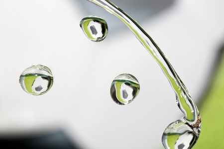 Drops of clear water with reflection of soccer ball の写真素材