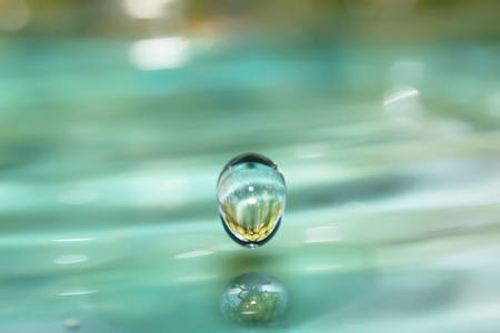 Drops of clear, blue water with reflection of grape  の写真素材