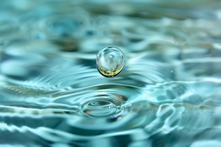Drops of clear, blue water with reflection of grape  の写真素材