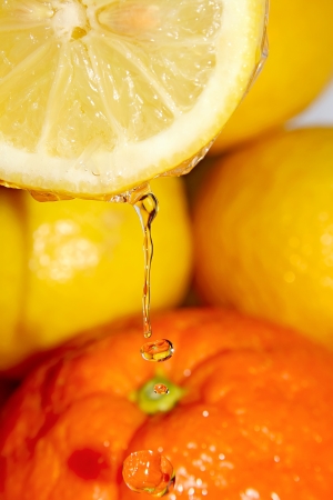 Drops of clear, crystal water with reflections from the orange background の写真素材