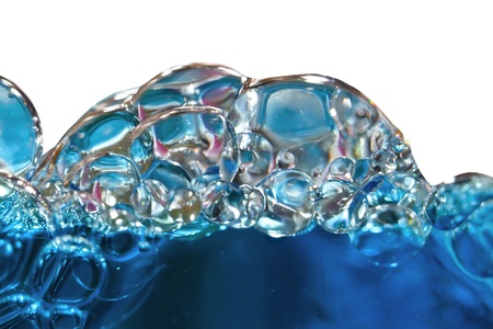 Blue bubbles in clear water against whiteの写真素材