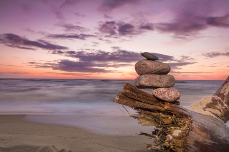 Sunset with pile of stones  Baltic sea in Poland  の写真素材
