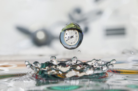 Surrealism. Drop of time. Play with water and clocks.