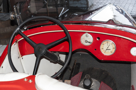 Old red car. Interior with steering wheel.の写真素材