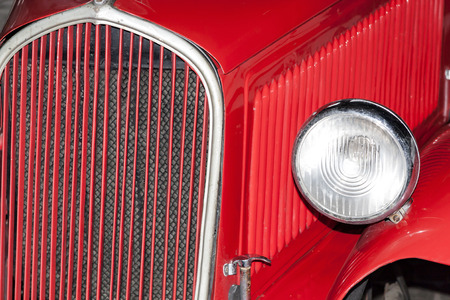 Old red car. Headight and red hood.の写真素材