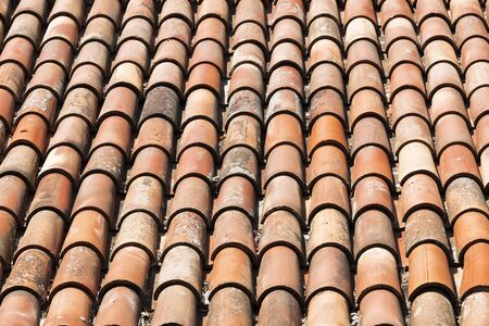 Background with the tiled roof. Old red rustic tiles.の写真素材