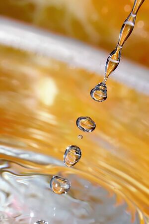 Splashed water drops. Fresh Orange Water. Natural background.の写真素材