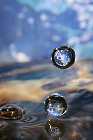Splashed water drops. Fresh, blue water. Natural background.の写真素材