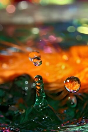 Drop on a feathers, mixed light and colors.の写真素材