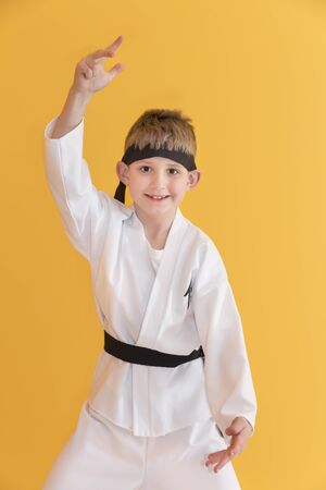 Boy age 7 fighting like karate playerの写真素材