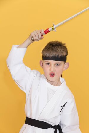 Boy age 7 fighting like karate playerの写真素材