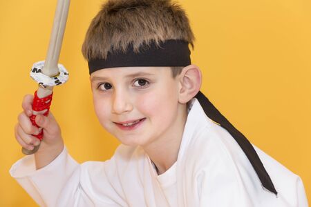 Boy age 7 fighting like karate playerの写真素材
