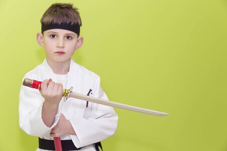 Boy age 7 fighting like karate playerの写真素材